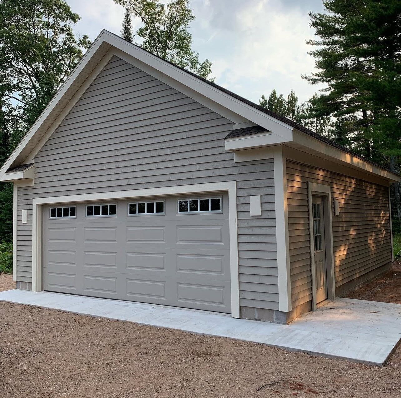 Detached garage with freshly painted siding and trim